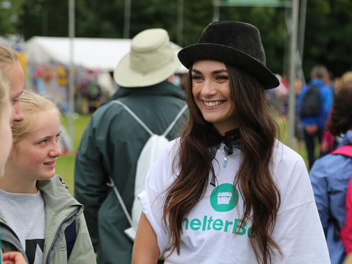 A lady chatting to young people about Shelterbox
