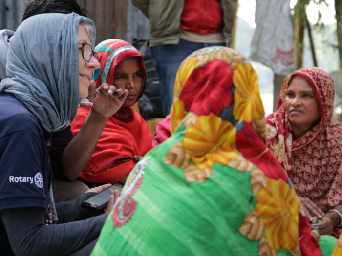 women gathered around in a circle talking