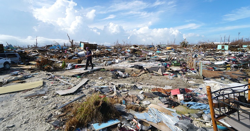 Person walking through rubble left behind by Hurricane Dorian