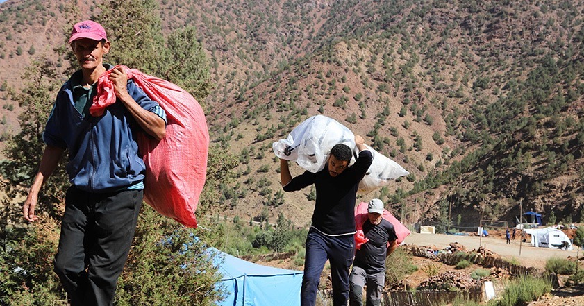 People carrying bags of aid in Morocco