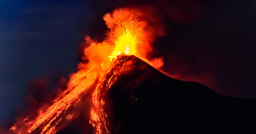 Volcano erupting at night